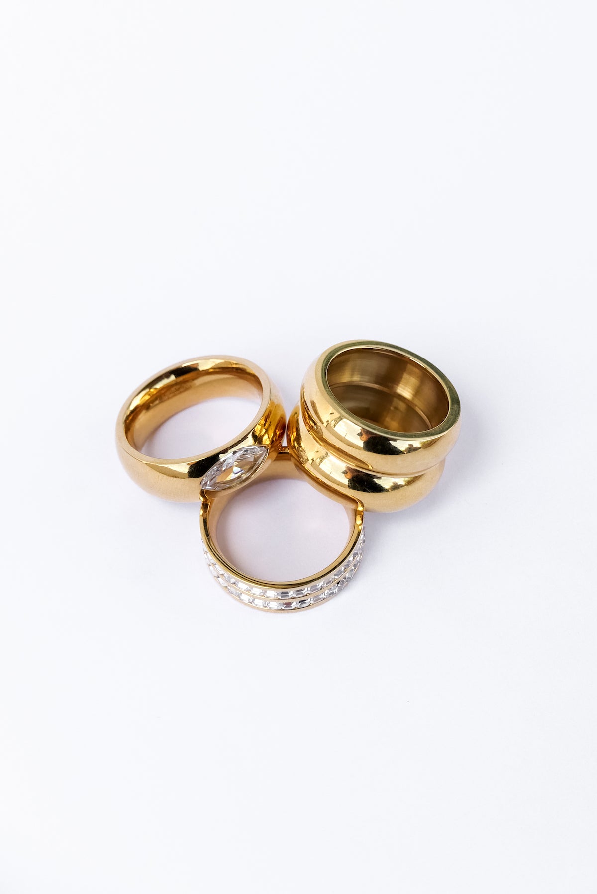 From Left to right: Spotlight ring, Be extra ring and goals ring stacked on a white backdrop