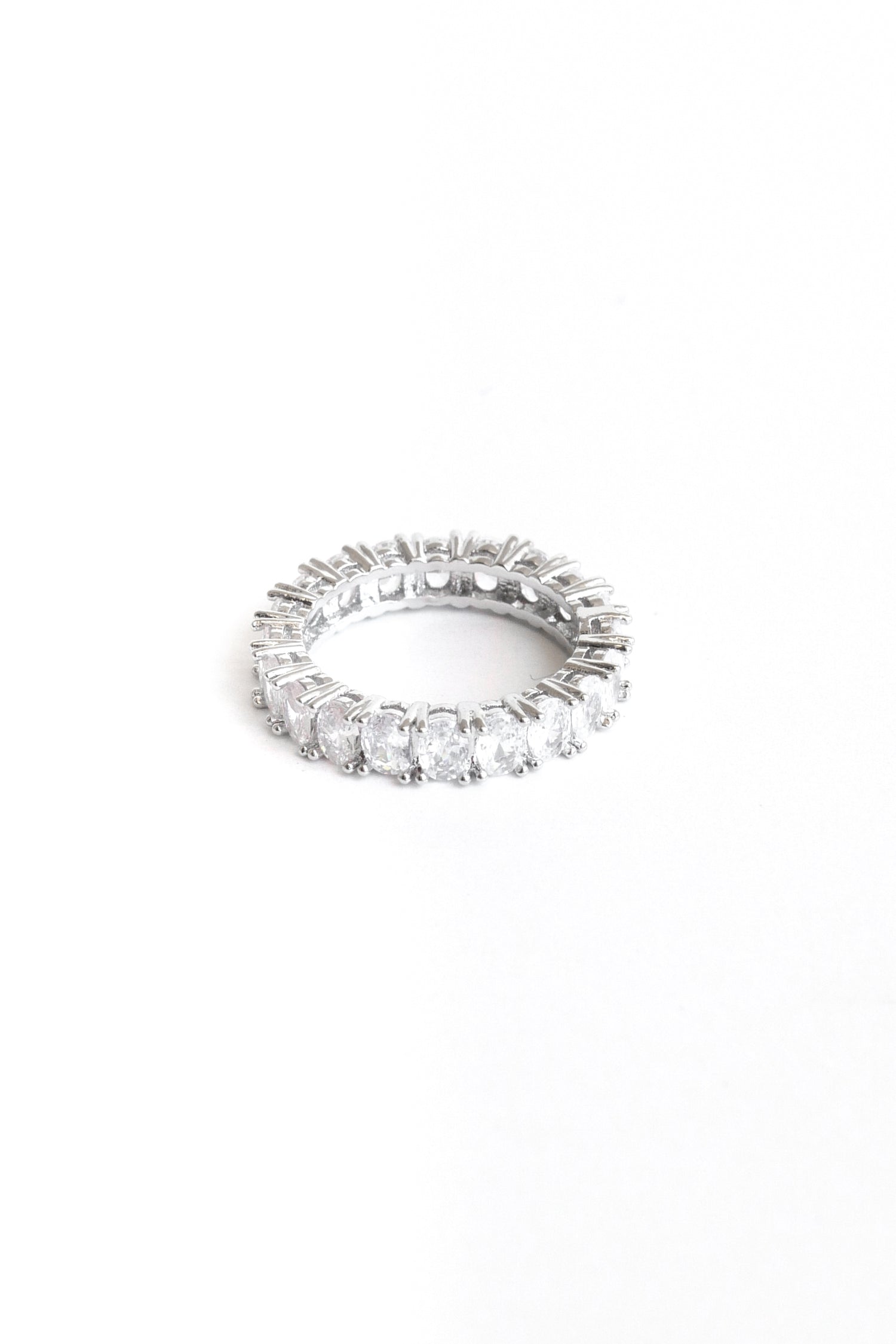 Oval Amor band ring lay flat against a white backdrop