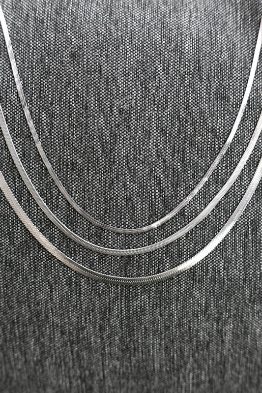 All three heavenly necklace sizes on a gray cloth backdrop 
