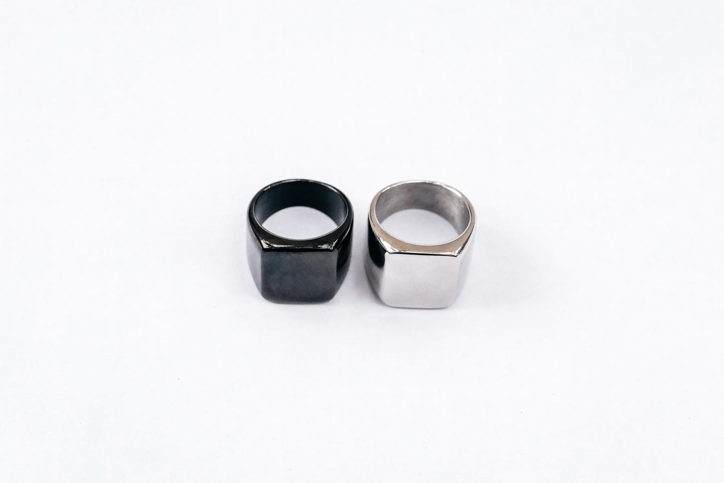 Black and silver amor bold mens ring on white backdrop 