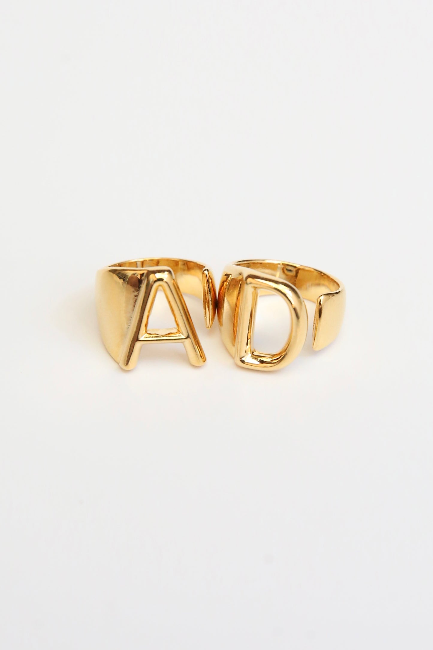 14k Gold AD ring set. A and D open banded ring on a white backdrop