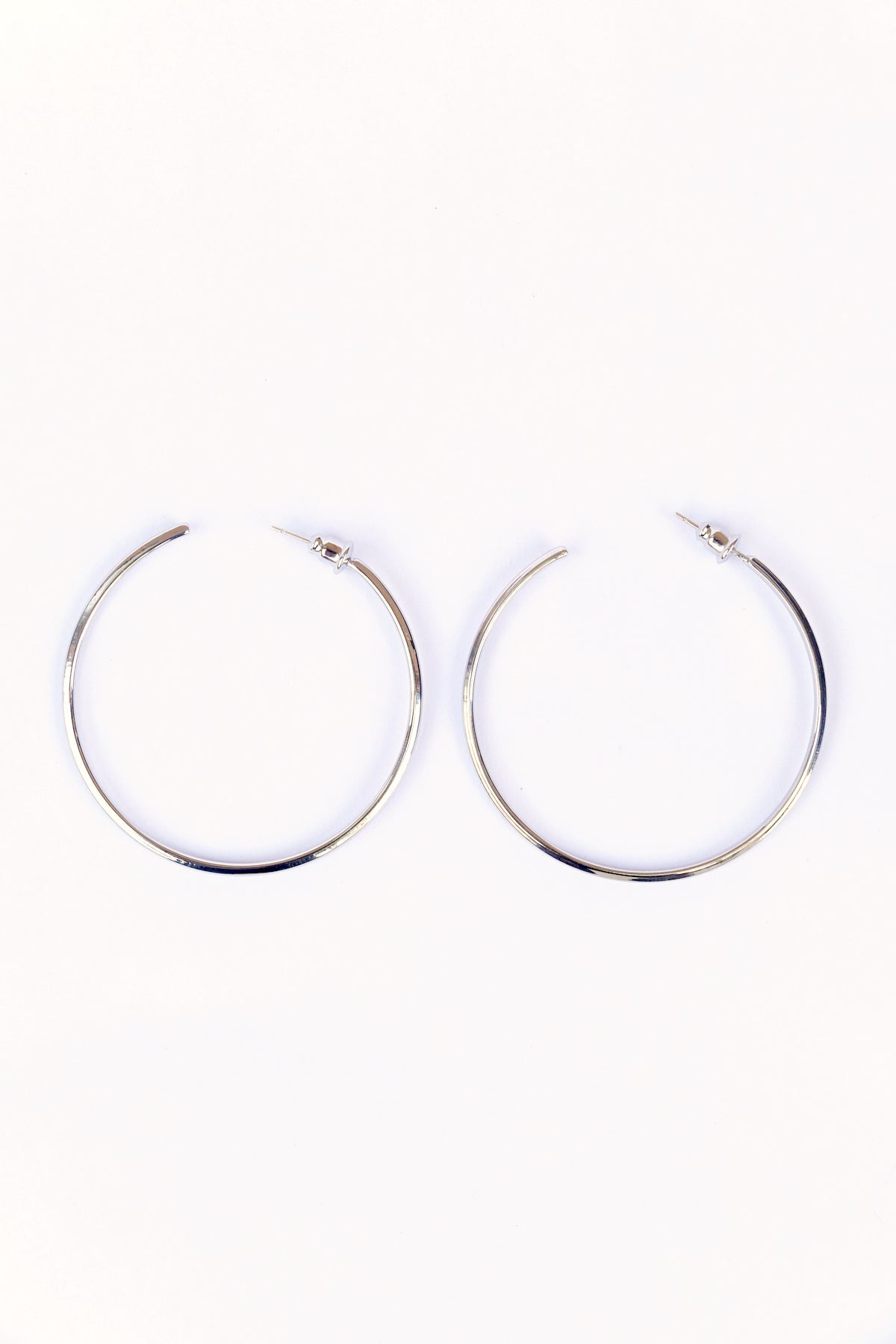 Silver Modern hoop earrings on a white backdrop