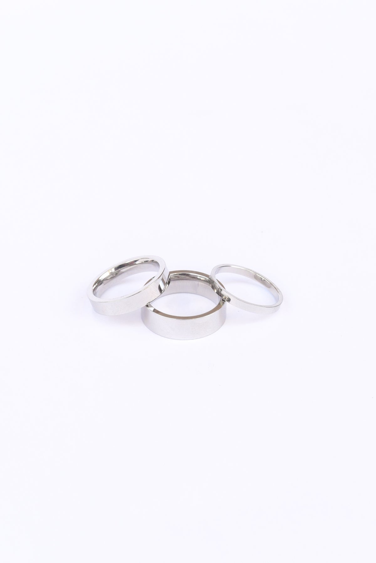 Silver banded Amor ring set on a white backdrop