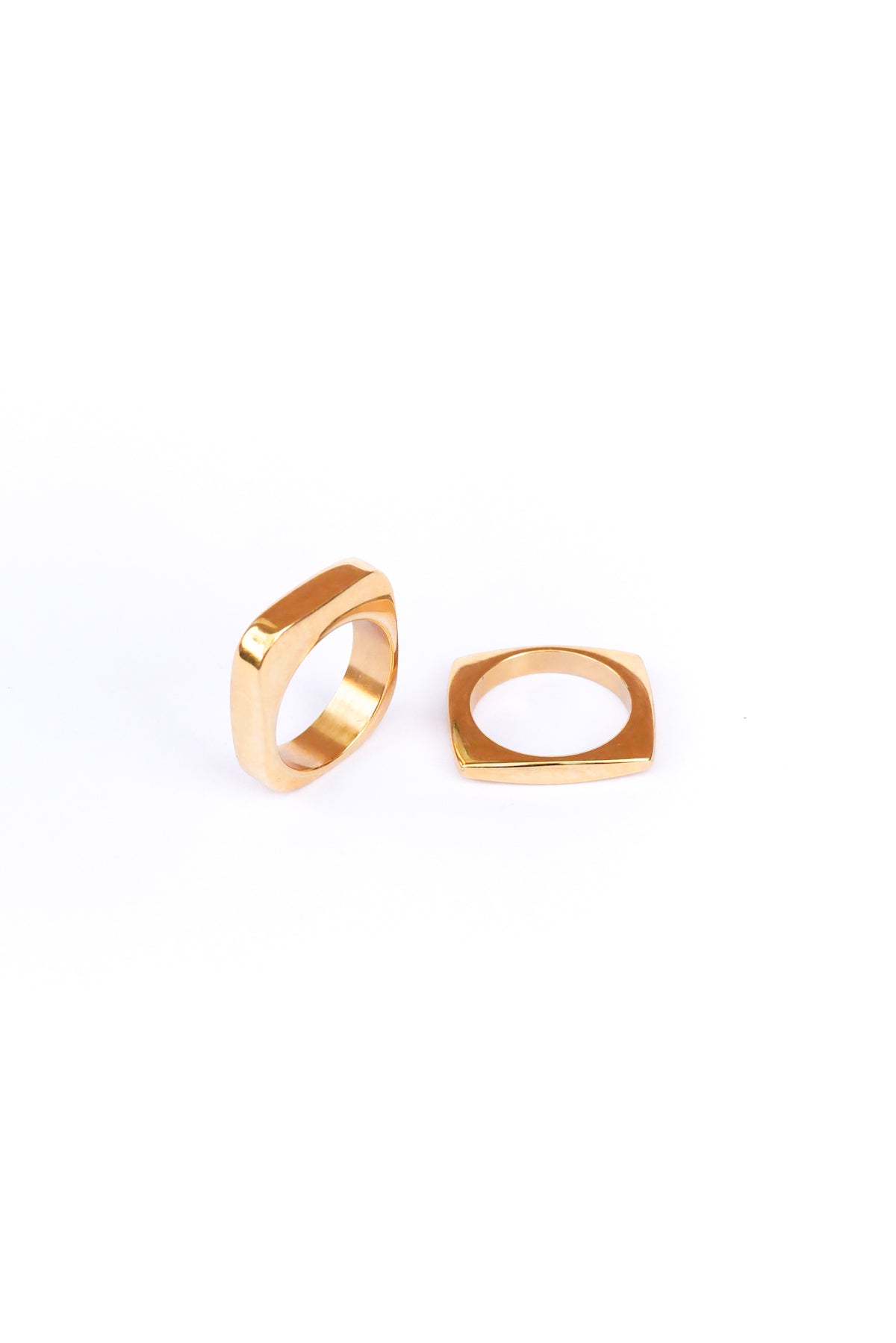 Two out of the box rings on a white backdrop one lays flat while the other stands on its side